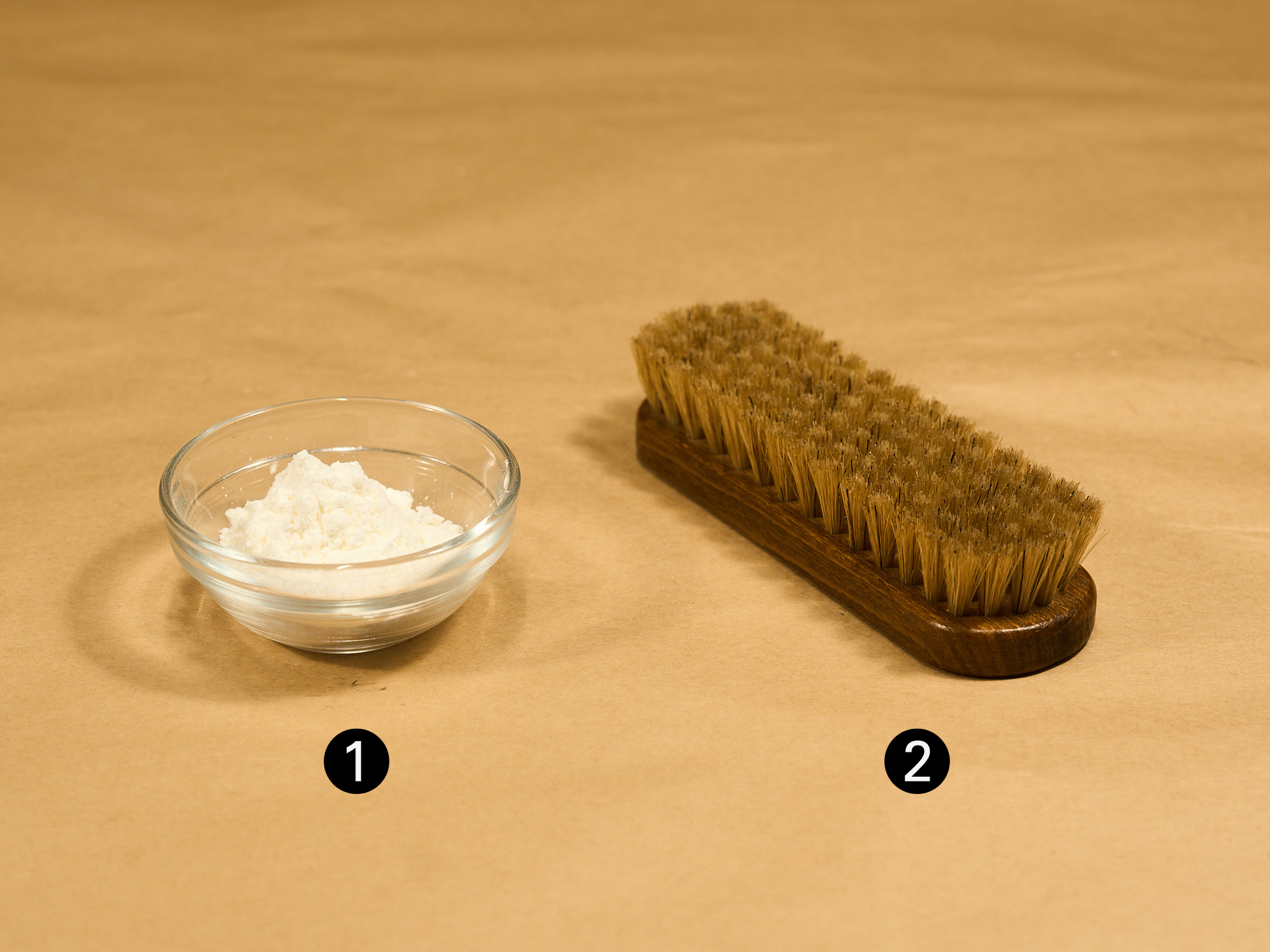 Cornstarch and a pig bristle brush for removing oil stains from suede shoes