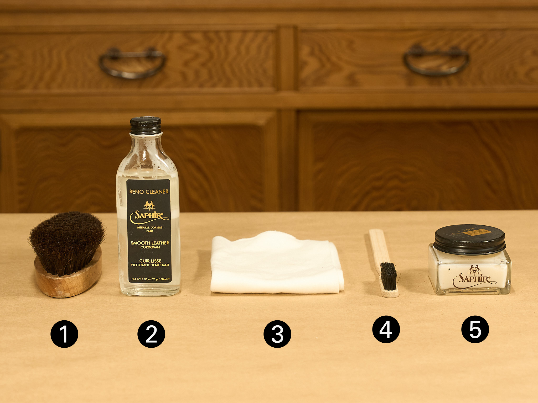 Tools for removing mold from leather shoes: a horsehair brush, leather shoe cleaner, cloths, and cream