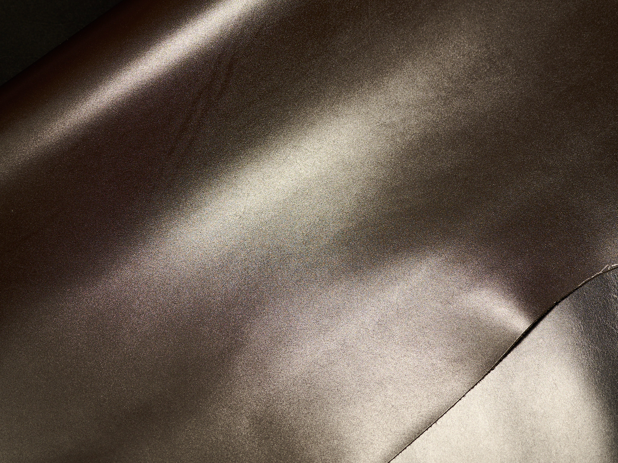 Deep brown smooth leather texture in close-up