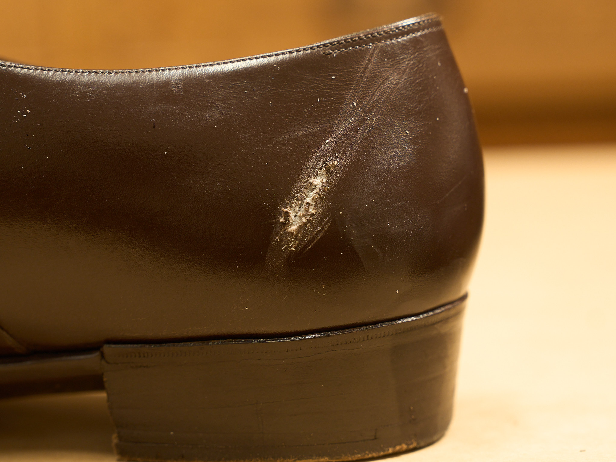 Worn leather shoe heel with scratches